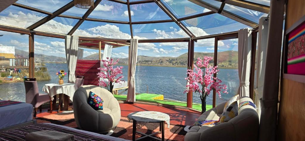 a living room with a view of the water at Titicaca Mia Lodge Perú in Puno