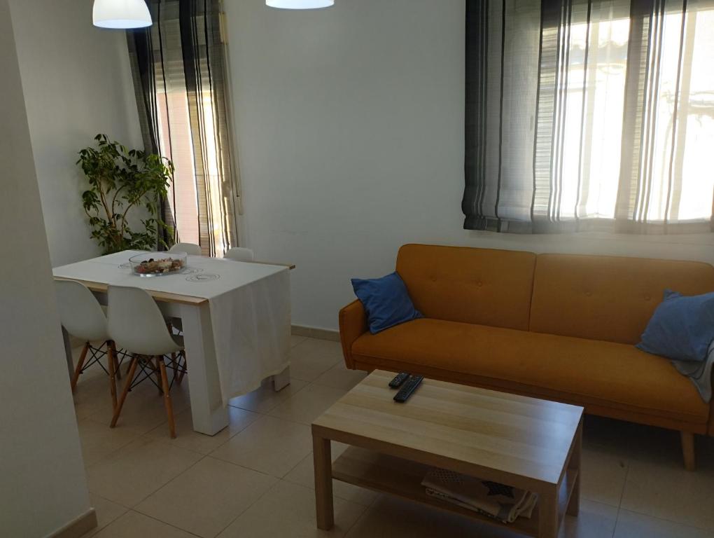 a living room with a couch and a table at Apartamentos calatorao con jardín y 3 habitaciones in Calatorao
