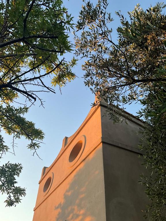 a tall tower with trees on top of it at Casottino presso residenza Rosso di Sera in Capoliveri