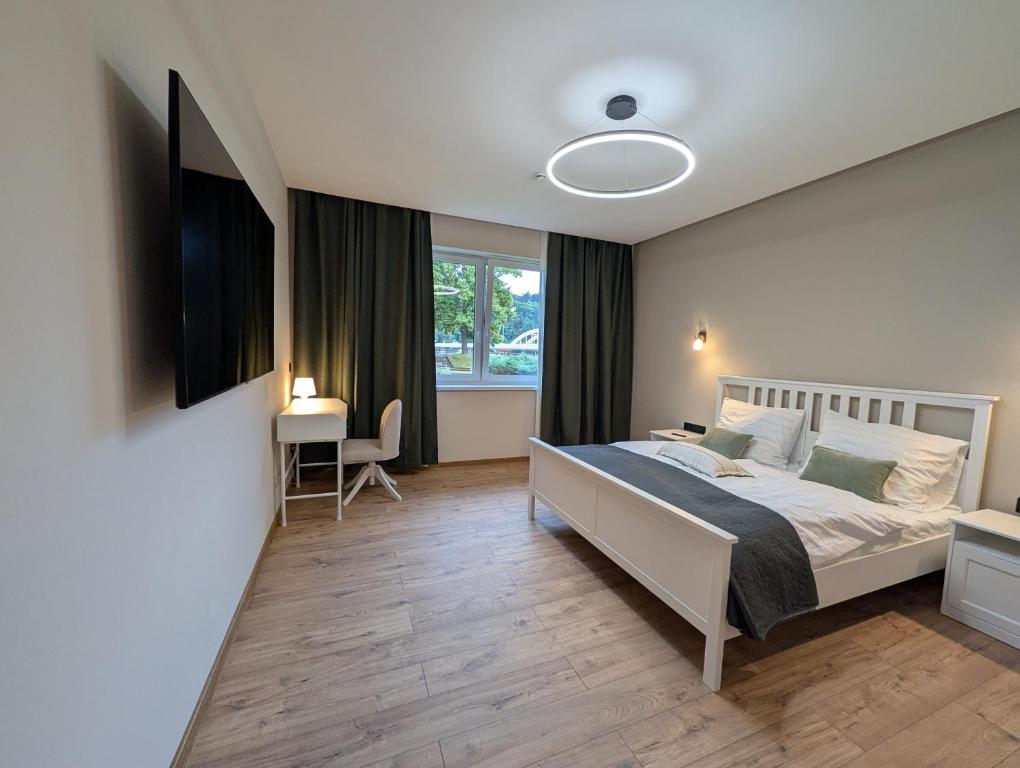 a bedroom with a large bed and a window at Apartmány Villa Vician in Piešťany