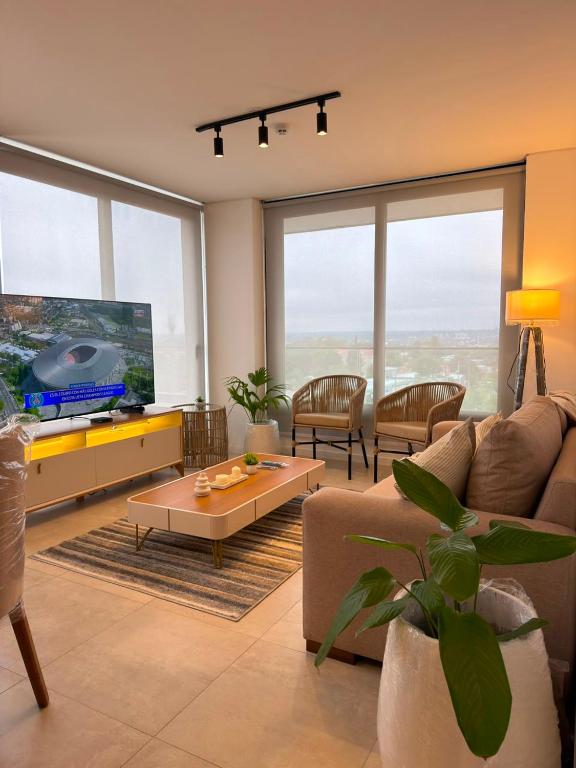 a living room with a couch and a flat screen tv at Feel Premiun 2408 in Asunción
