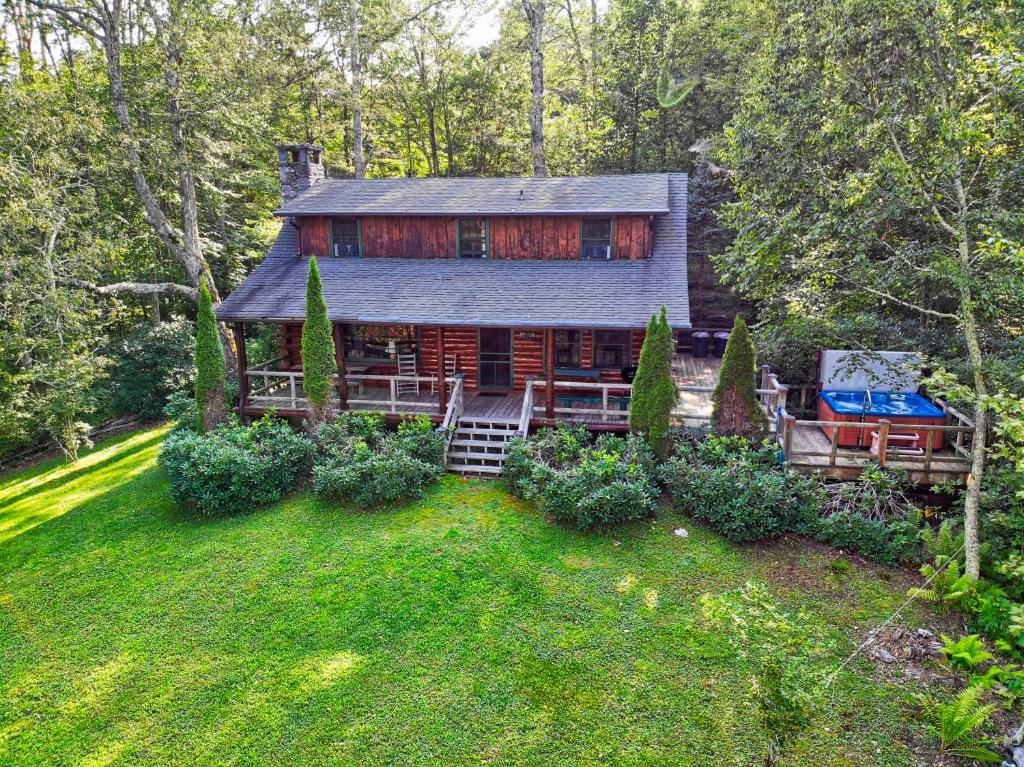 an aerial view of a log cabin with a yard at Winds Aloft in Newland