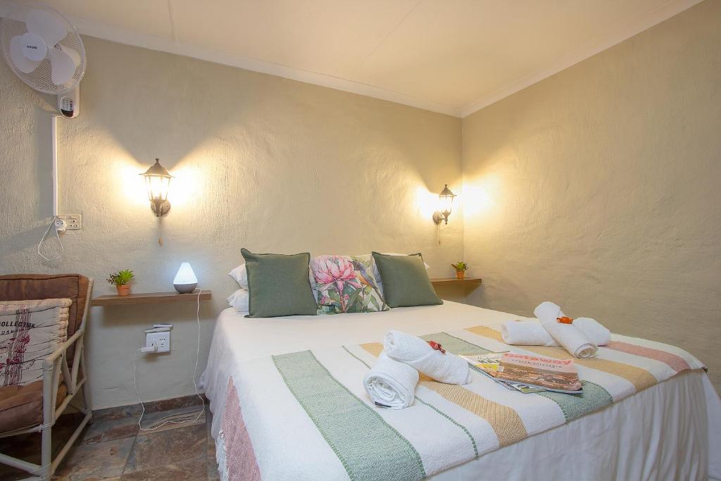a bedroom with a bed with towels on it at Baobab at 36 Rissik in Komatipoort