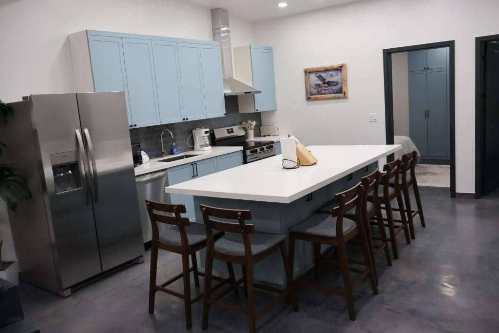 a kitchen with a white counter top and a refrigerator at Glacier Luxury Retreat Montana Sky Apartment 2 in Hungry Horse