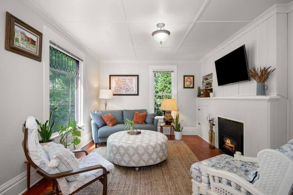 a living room with a couch and a fireplace at Chic Vintage Vibes Stylish Stay Near It All in Spokane