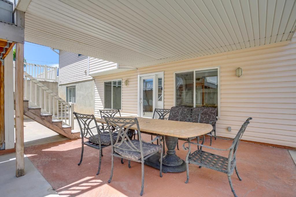 a table and chairs on the porch of a house at Easy AFB Commute! Clearfield Unit w/ Private Patio in Clearfield