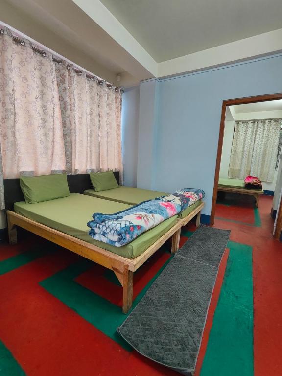 a bed sitting in a room with a mirror at Pine Forest Home stay with City View in Shillong