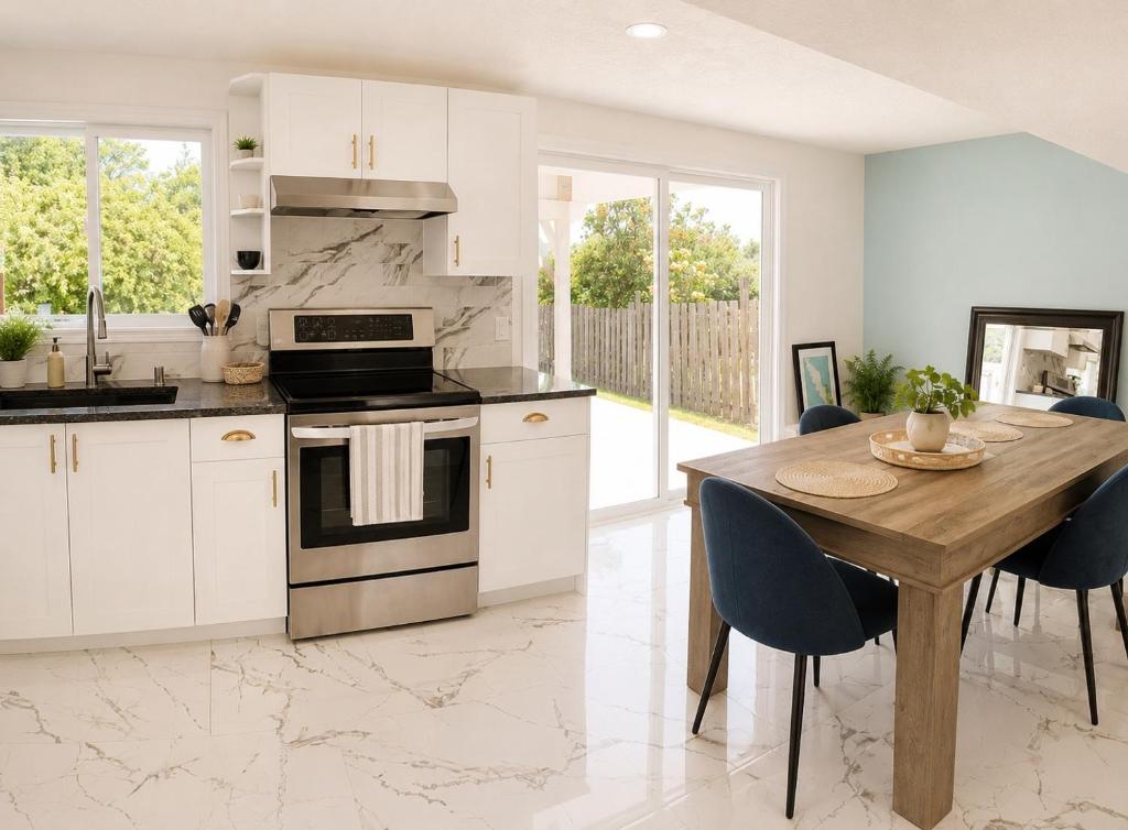 a kitchen with white cabinets and a wooden table at Lagoon Views Near Bird Sanctuary in Victoria