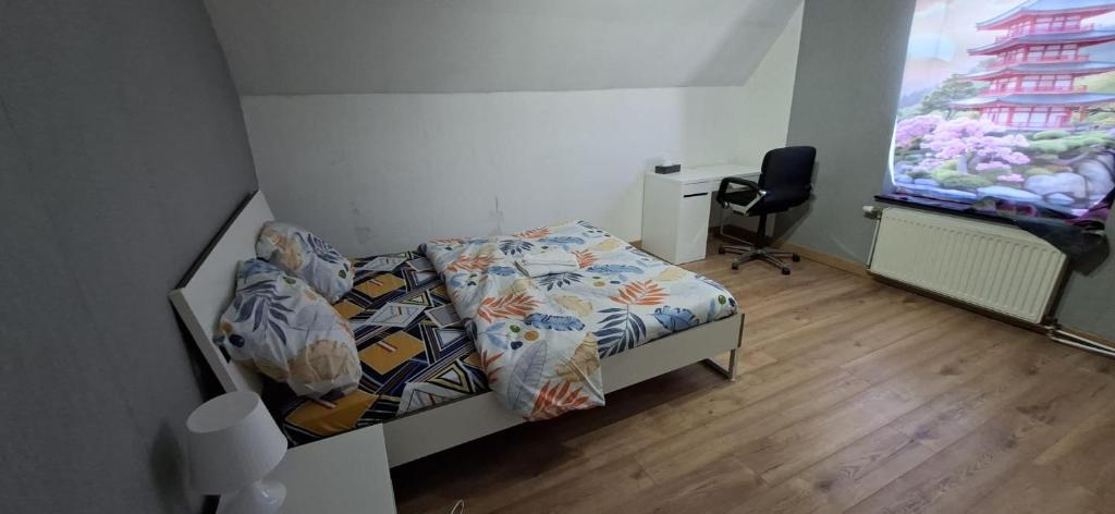 a small bedroom with a bed and a window at Belle chambre 2 in Seraing