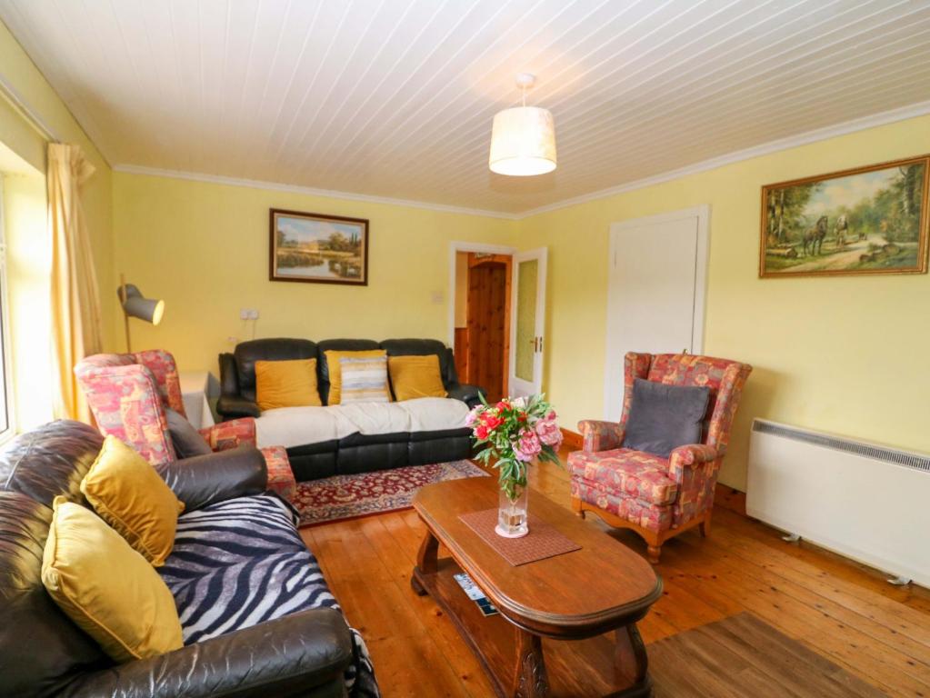 a living room with a couch and a table at Forest View in Teeranearagh