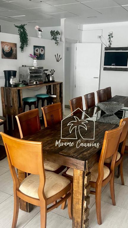 a wooden table with chairs and a dining room at Mírame Canarias in Vecindario