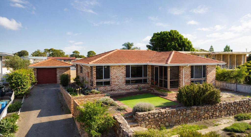 a brick house with a retaining wall and a yard at Smugglers Cove in Esperance