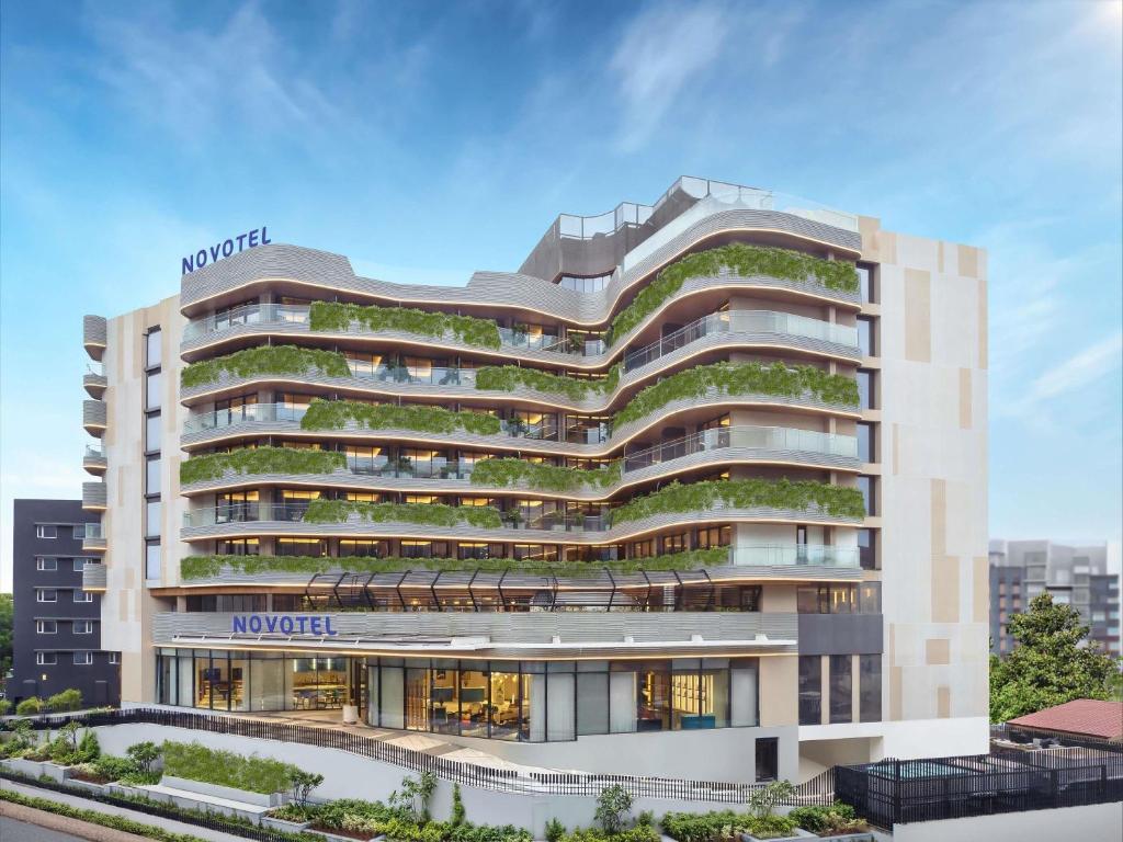 an architectural rendering of a hotel building with green vegetation at Novotel Goa Panjim in Panaji
