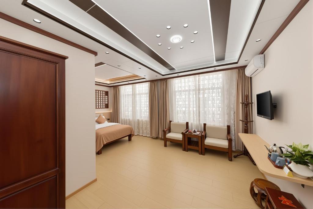 a hospital room with a bed and a tv at Dali Classical Rosewood Boutique Inn in Dali