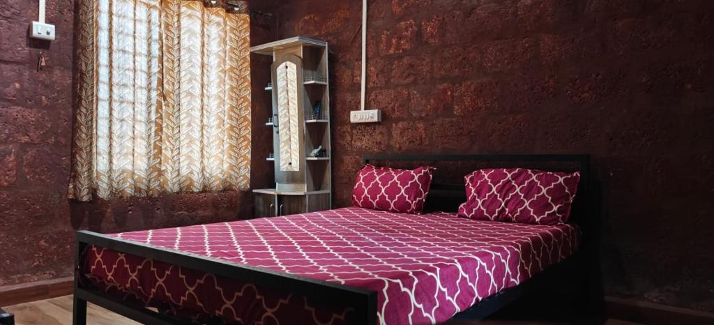 a bedroom with a bed with a purple comforter at Samarpit Guest House in Devgarh