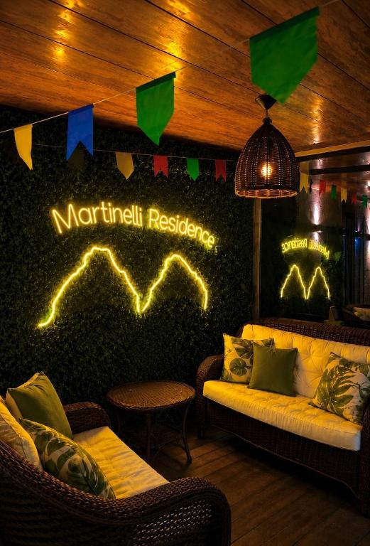 a room with a couch and a wall with a sign at Martinelli Residence in Fernando de Noronha