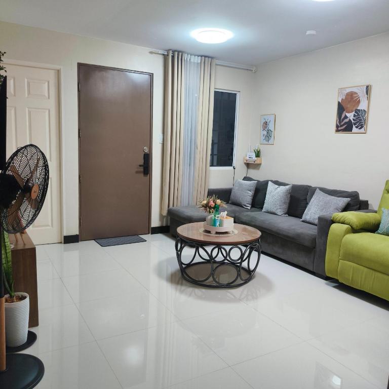 a living room with a couch and a table at Villa Bosque - Forest Residences in Antipolo
