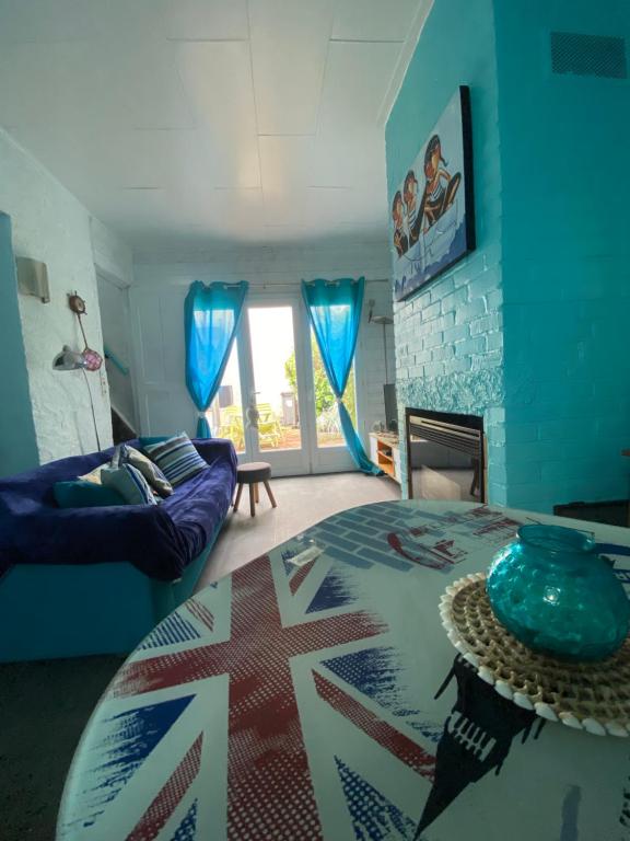 a living room with a bed and a table in a room at Maison de pêcheurs les petits quinquins in Étaples