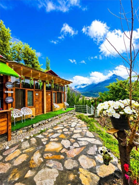a house in the mountains with a stone driveway at Escape Retreat Hunza in Karimabad Hunza