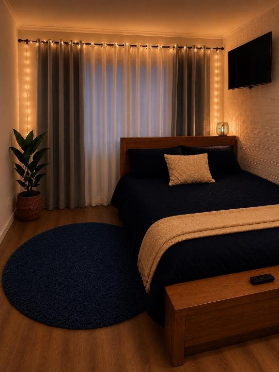 a bedroom with a large bed with lights on it at Garden Studio with Private Patio in Wentworth Falls