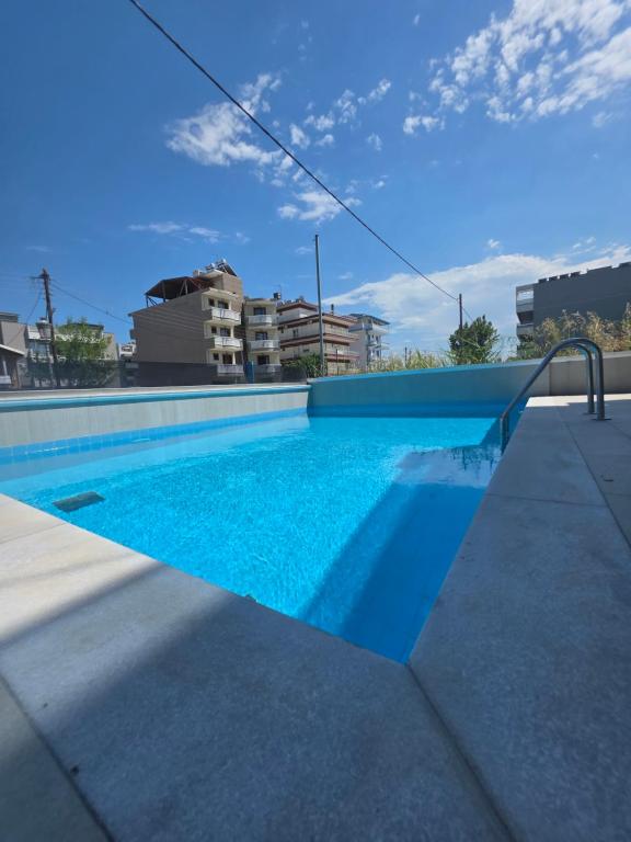 a swimming pool with blue water in a building at BmB apartments in Paralia Katerinis