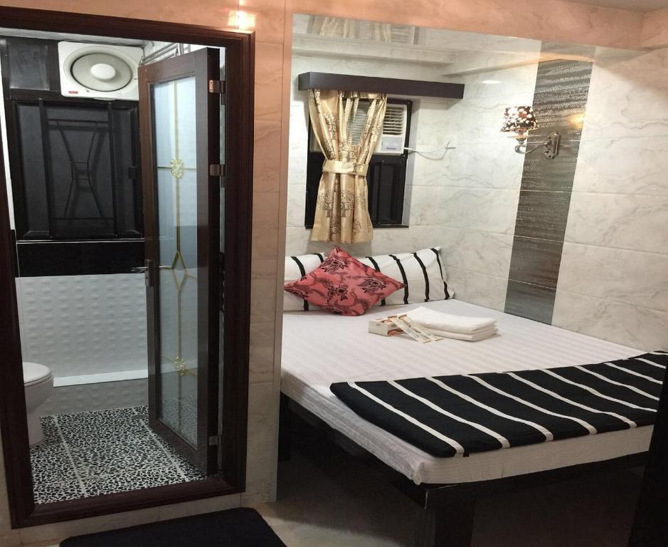 a small bedroom with a bed and a shower at Skyview Hostel in Hong Kong