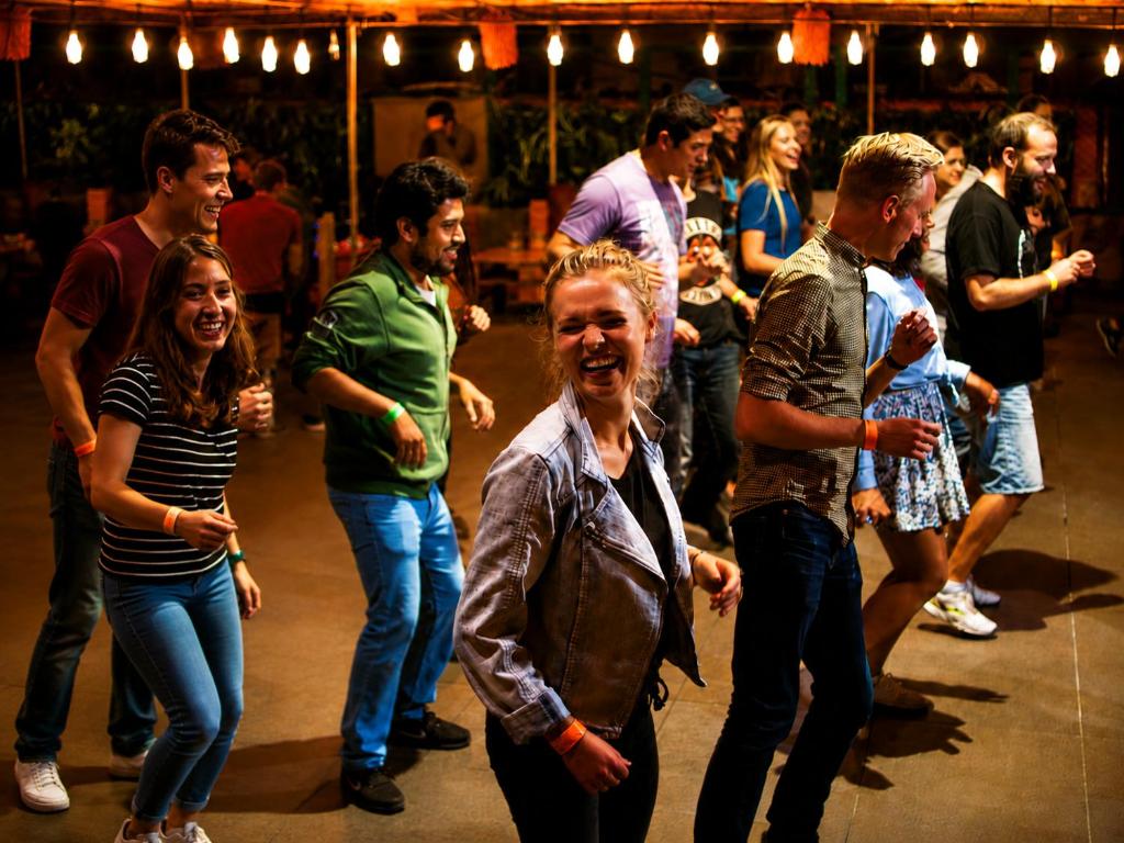 a group of people dancing on a dance floor at Pariwana Hostel Lima in Lima