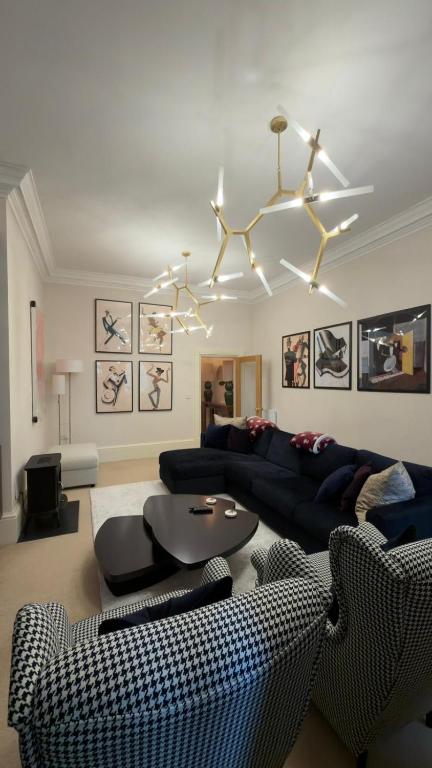 a living room with a couch and a table at Rutland Home in Langham