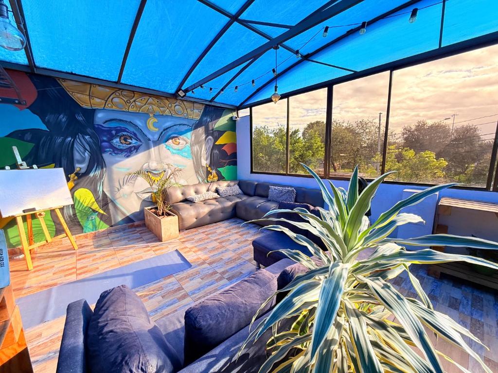 a room with a couch and a painting on the wall at Bababuy Hostel in Bogotá
