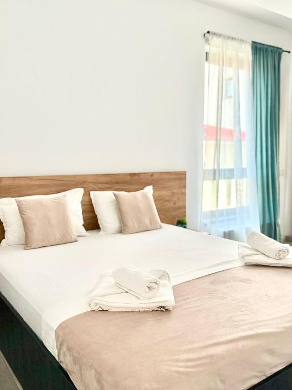 two beds with towels on top of them in a bedroom at Serene Studios in Eforie Nord
