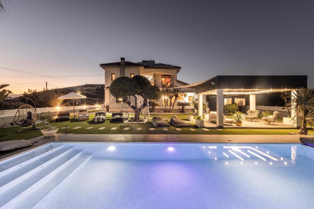 a swimming pool in front of a house at Kasparis View Residence in Pano Lefkara