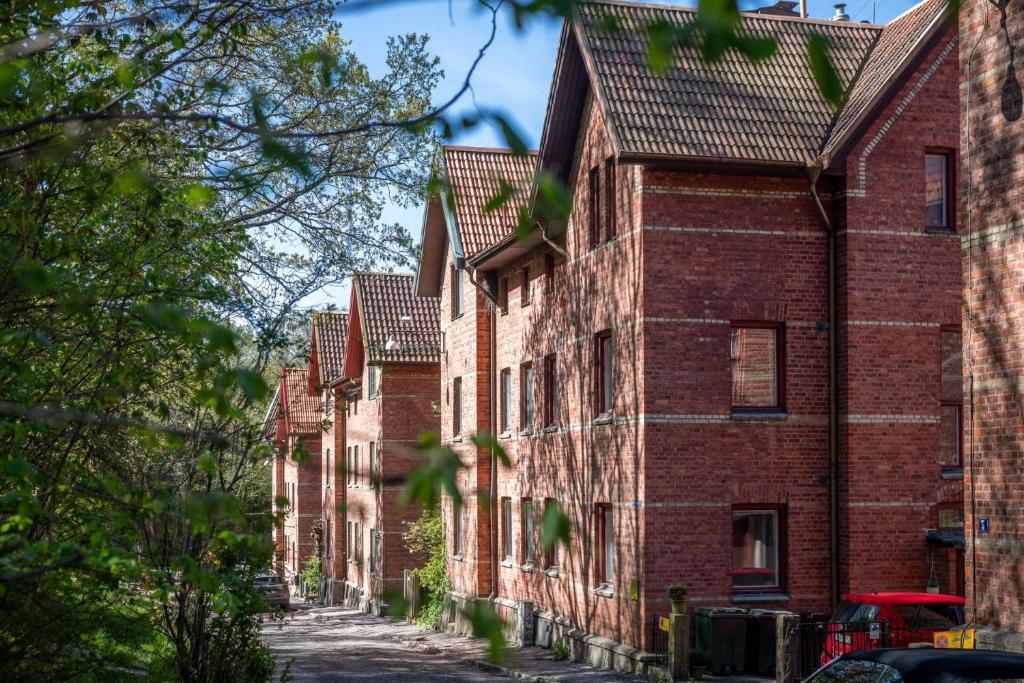 a row of brick buildings on a street at C Apartments Annedal in Gothenburg