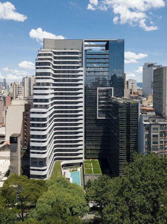 a tall building in a large city with trees at Setin Downtown | Conforto no Centro de SP in São Paulo