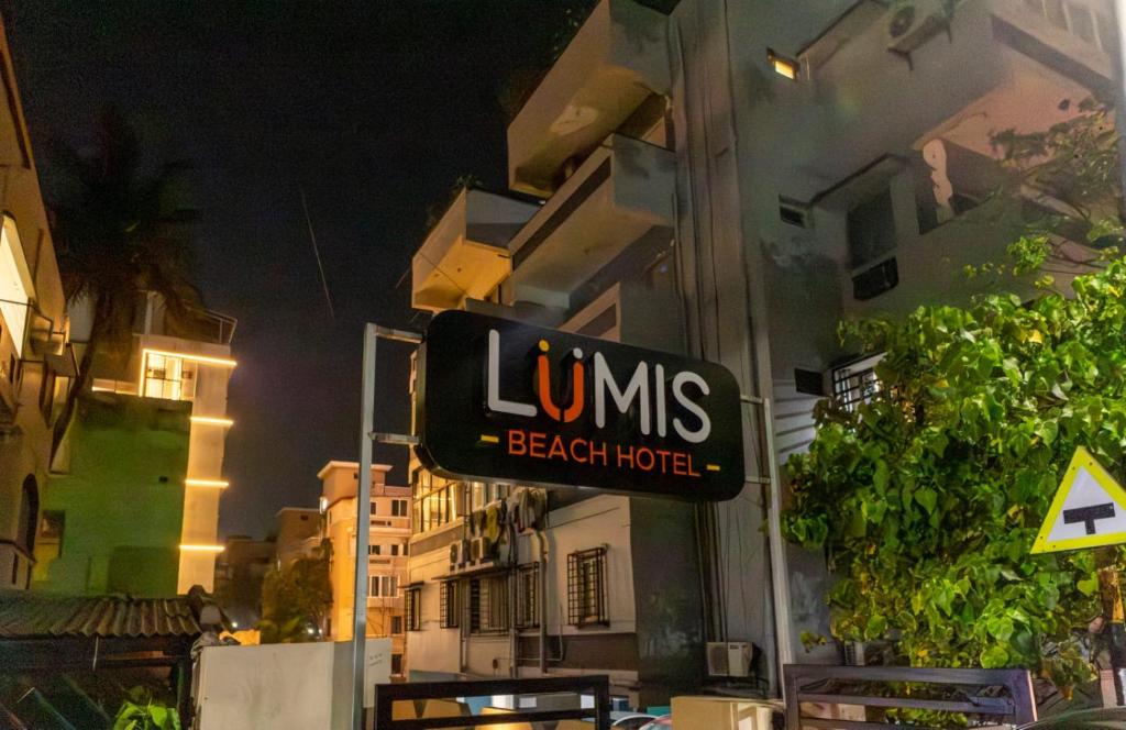 a sign for a beach hotel on the side of a building at Lumis Beach Hotel in Visakhapatnam