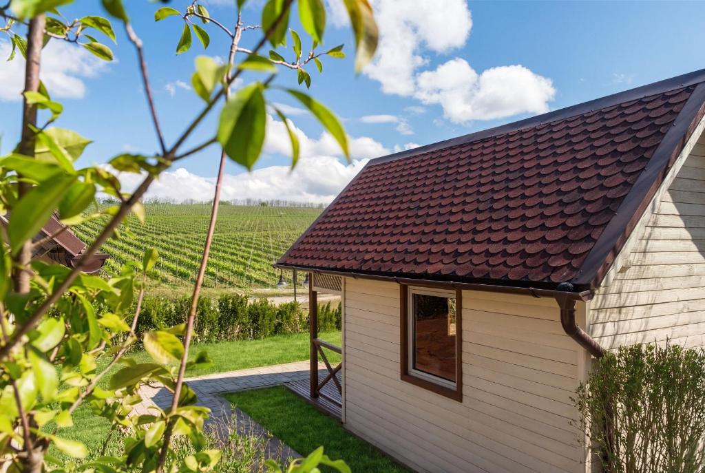 a small white building with a brown roof at ISSA Village in Turda