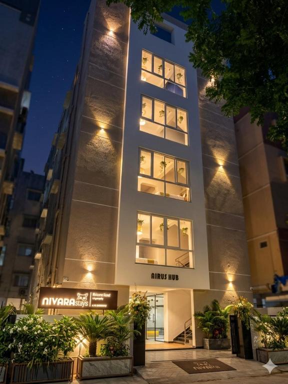 a tall building with lights in front of it at Nivara Stays Lingampalli, A Boutique Hotel Brand in Hyderabad