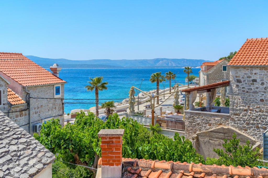a view of a town with the ocean in the background at Villa Majestic with heated pool and rooftop terrace in Bol
