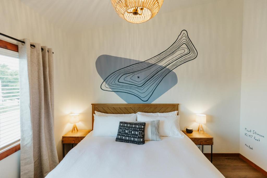 a bedroom with a bed with a instrument on the wall at Mt Stimson Suite Work-From-Anywhere-Ready in Kalispell
