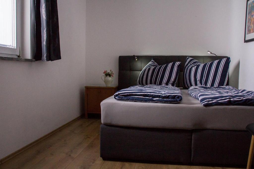 a bed with two pillows on it in a room at Ferienwohnung Götzis in Götzis