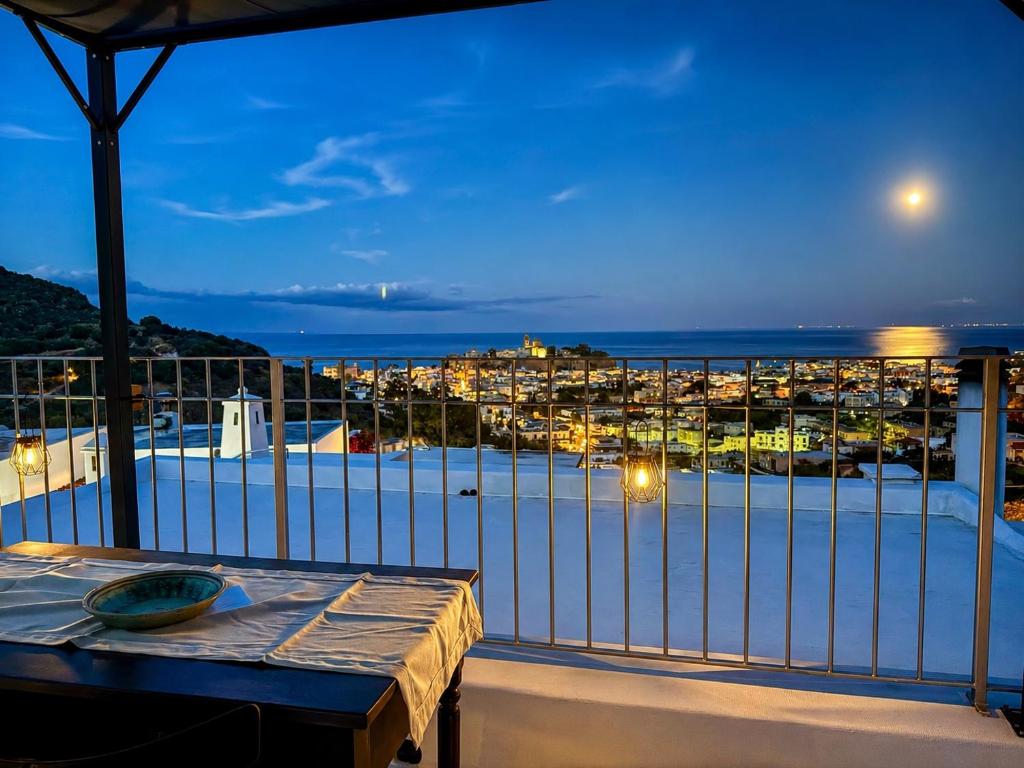 a balcony with a table and a view of a harbor at Holiday Home Tarinuzza in Lipari