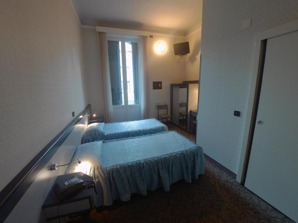 Postel nebo postele na pokoji v ubytování Hotel Ada