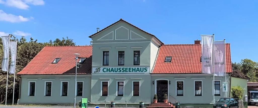 a building with a sign on the front of it at Chausseehaus - Ferienwohnungen Rottleberode am Harzrand in Rottleberode