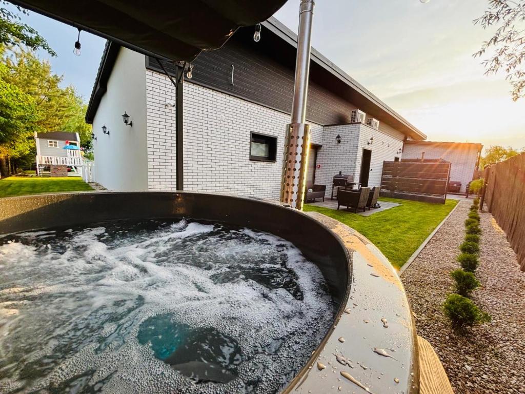 a hot tub in the backyard of a house at RAJSKIE REZYDENCJE-Antresola Czarna,Antresola Biała in Bilcza