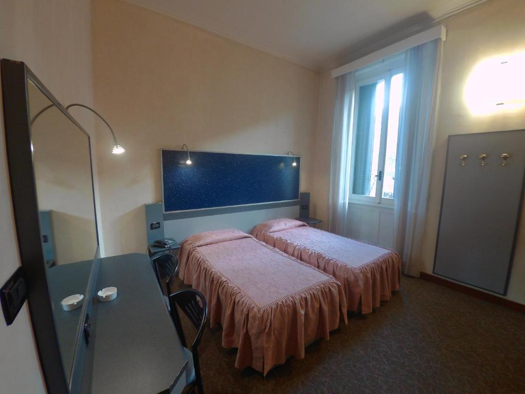 Postel nebo postele na pokoji v ubytování Hotel Ada