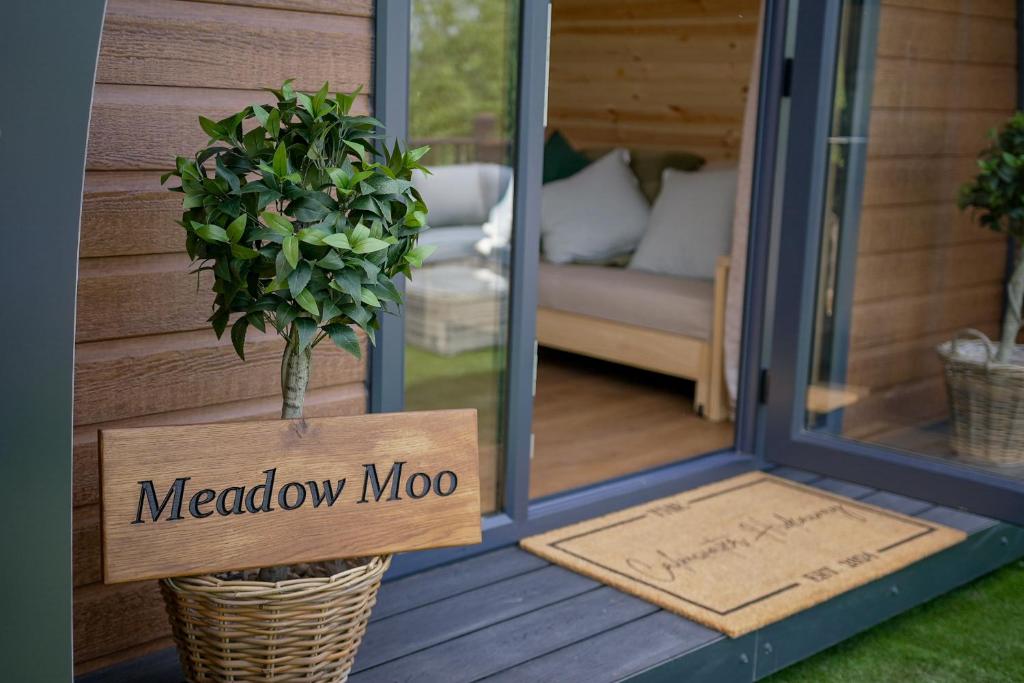 a door with a meadow moo sign on a porch at Calmwater Hideaway in New Hey