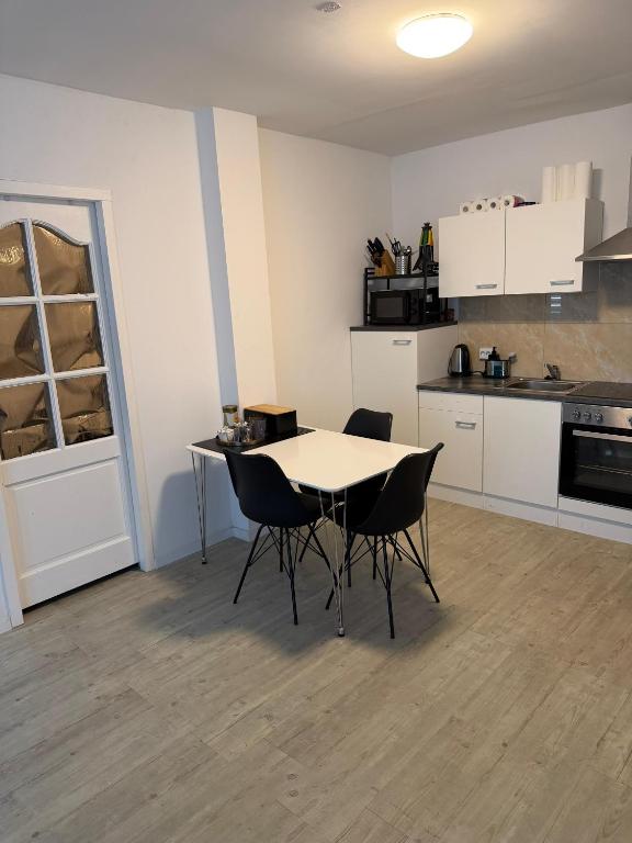 a kitchen with a table and chairs in a room at Casaejon in Lelystad