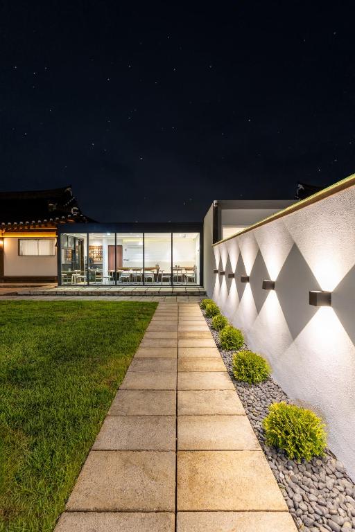 an exterior view of a house at night with lights at 한옥스테이 화랑루 in Gyeongju