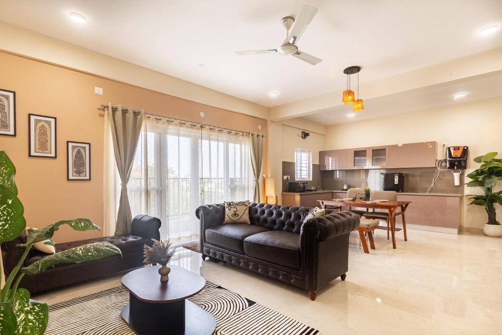 a living room with a couch and a table at Altura in Bangalore