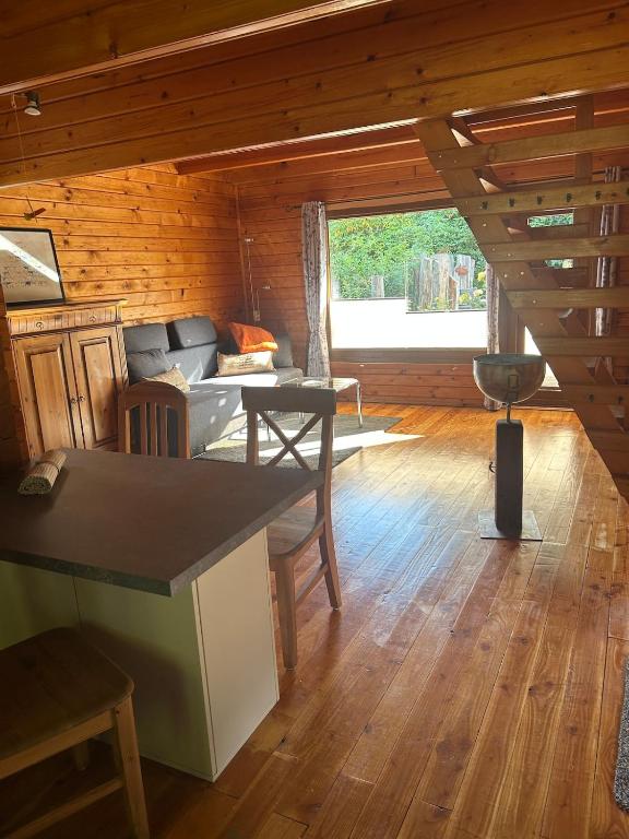 a living room with a couch and a table at Gemütliches Blockhaus in Harsefeld