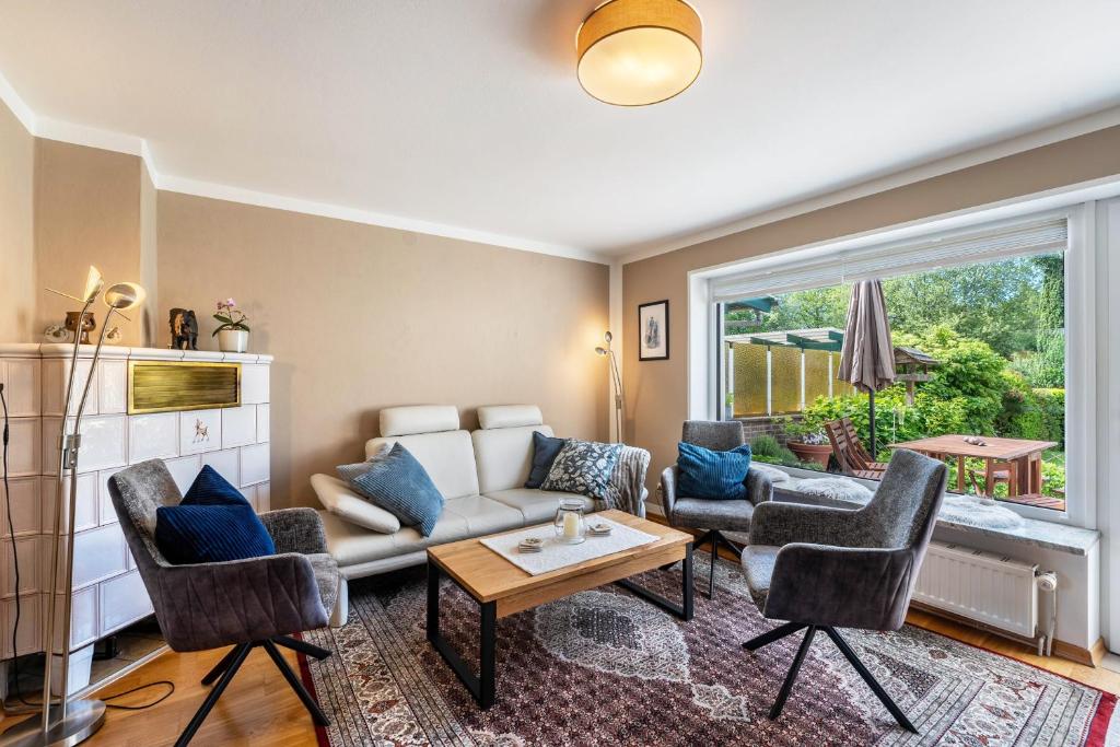 a living room with a couch and chairs at Park – House in Oldenburg in Holstein